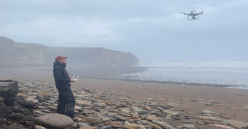 Newcastle University researchers fly a drone above Blast Beach during Storm Babet to measure the damage caused to the coastline